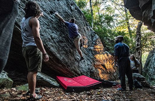 Four people bouldering at Coopers Rock State Park, WV.
