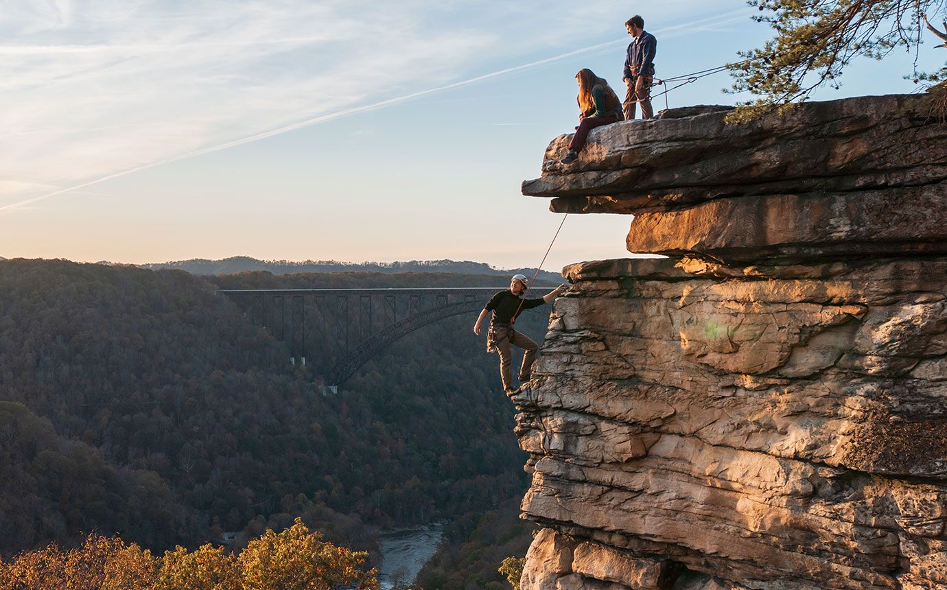 Climbers on edge of cliff in New River Gorge