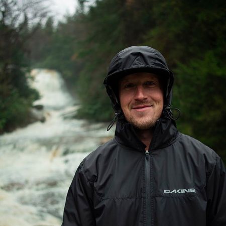 Portrait of Chris Zandron standing in front of a river